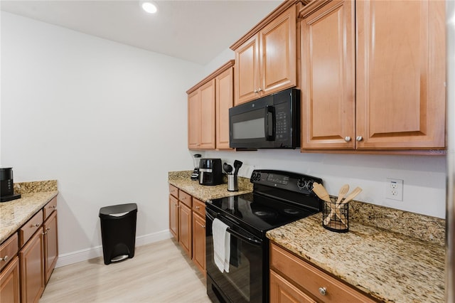 2923 Banana Palm Dr, Kissimmee, FL 34747 - kitchen with black appliances, light wood-style floors, baseboards, light stone countertops, and recessed lighting