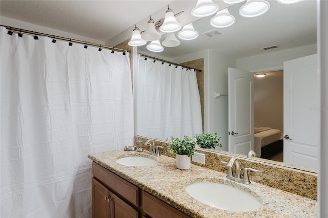 2923 Banana Palm Dr, Kissimmee, FL 34747 - bathroom with double vanity and a shower with shower curtain