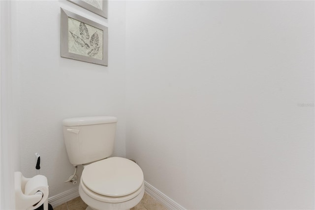 2923 Banana Palm Dr, Kissimmee, FL 34747 - bathroom featuring baseboards, toilet, and tile patterned flooring