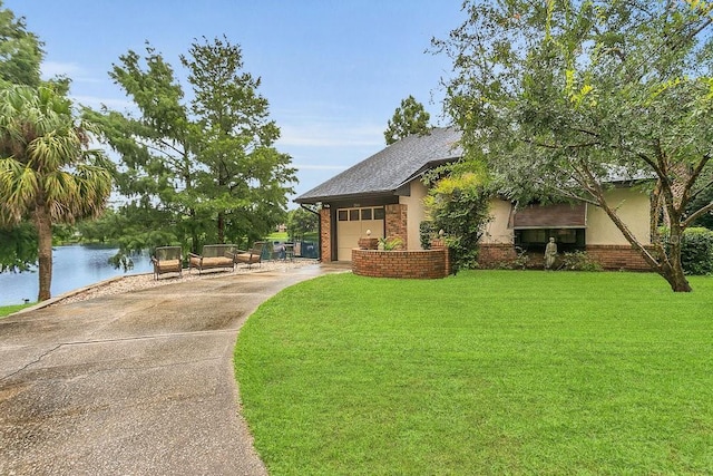3501 Danby Ct, Orlando, FL 32812 - view of home's community with driveway, a water view, a garage, and a yard