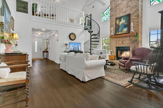 3501 Danby Ct, Orlando, FL 32812 - living room with a towering ceiling, stairs, wood finished floors, healthy amount of natural light, and a fireplace