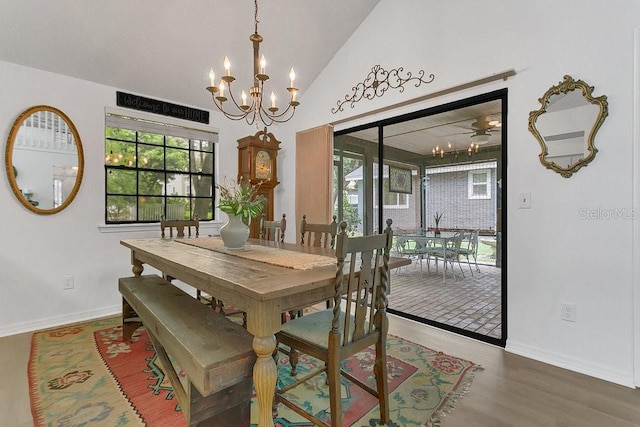 3501 Danby Ct, Orlando, FL 32812 - dining space with a chandelier, wood finished floors, vaulted ceiling, and baseboards