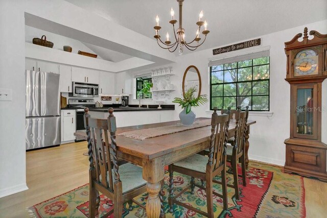 3501 Danby Ct, Orlando, FL 32812 - dining space with a chandelier, light wood finished floors, and baseboards