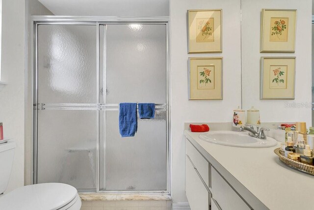 3501 Danby Ct, Orlando, FL 32812 - bathroom featuring toilet, vanity, and a shower stall
