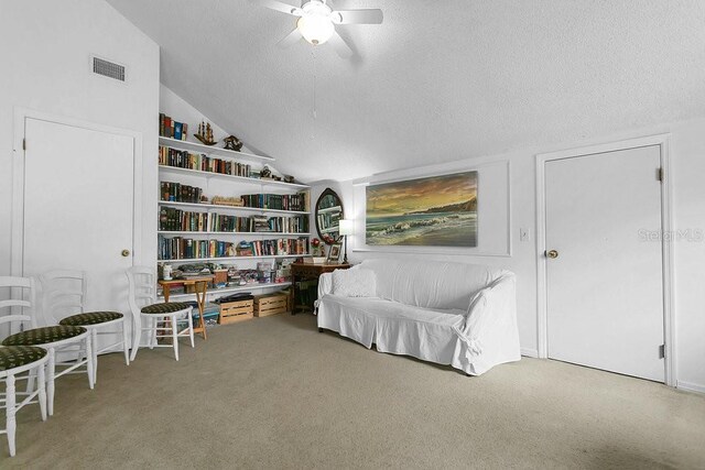 3501 Danby Ct, Orlando, FL 32812 - living area with vaulted ceiling, carpet, a ceiling fan, and a textured ceiling