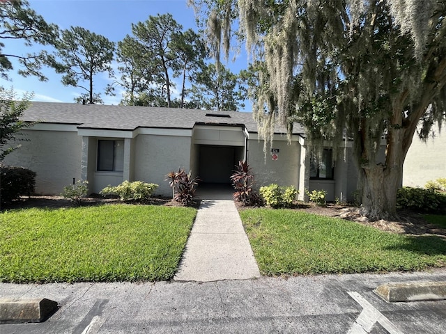 124 Springwood Cir Unit B, Longwood, FL 32750 - mid-century modern home featuring stucco siding and a front yard