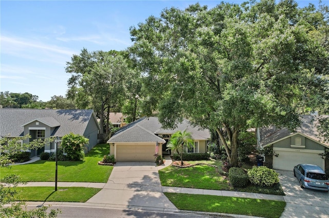1354 Dutch Elm Dr, Altamonte Springs, FL 32714 - view of front of property with driveway, an attached garage, and a front lawn