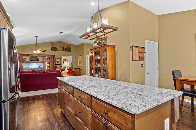 1354 Dutch Elm Dr, Altamonte Springs, FL 32714 - kitchen featuring stainless steel refrigerator with ice dispenser, dark wood-type flooring, vaulted ceiling, a ceiling fan, and light stone counters