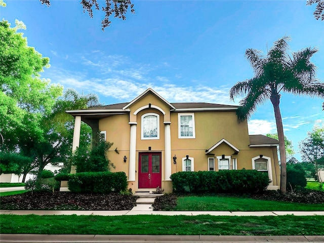 357 Fairway Pointe Cir, Orlando, FL 32828 - view of front facade with stucco siding, french doors, and a front yard