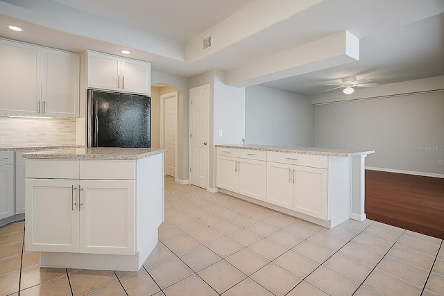 357 Fairway Pointe Cir, Orlando, FL 32828 - kitchen featuring high end fridge, a ceiling fan, arched walkways, recessed lighting, and a peninsula