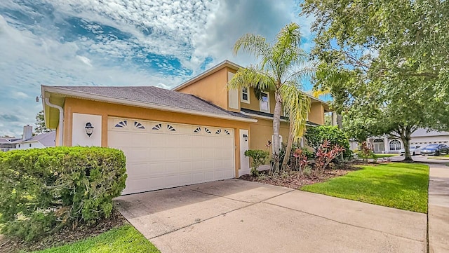 357 Fairway Pointe Cir, Orlando, FL 32828 - view of front facade featuring stucco siding, an attached garage, and driveway