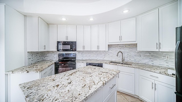 357 Fairway Pointe Cir, Orlando, FL 32828 - kitchen with black appliances, white cabinetry, and tasteful backsplash