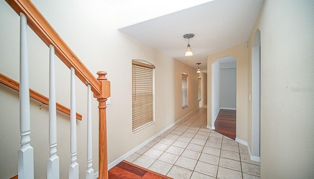 357 Fairway Pointe Cir, Orlando, FL 32828 - corridor with arched walkways, light tile patterned flooring, and stairway