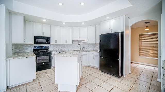 357 Fairway Pointe Cir, Orlando, FL 32828 - kitchen featuring black appliances, tasteful backsplash, arched walkways, white cabinetry, and recessed lighting