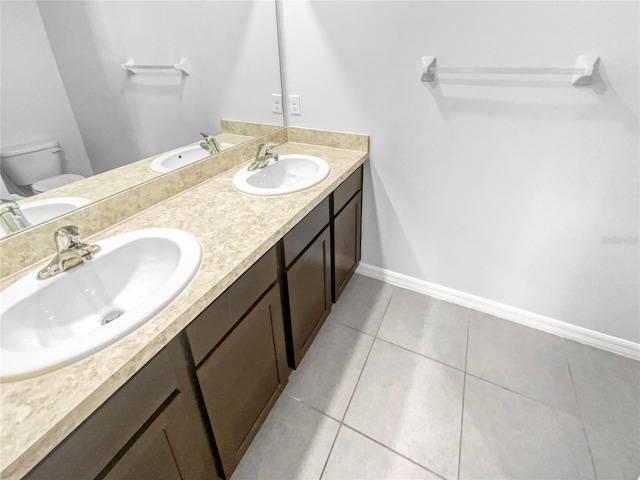 10956 Carlton Fields Dr, Riverview, FL 33579 - full bathroom featuring double vanity, toilet, tile patterned flooring, and baseboards