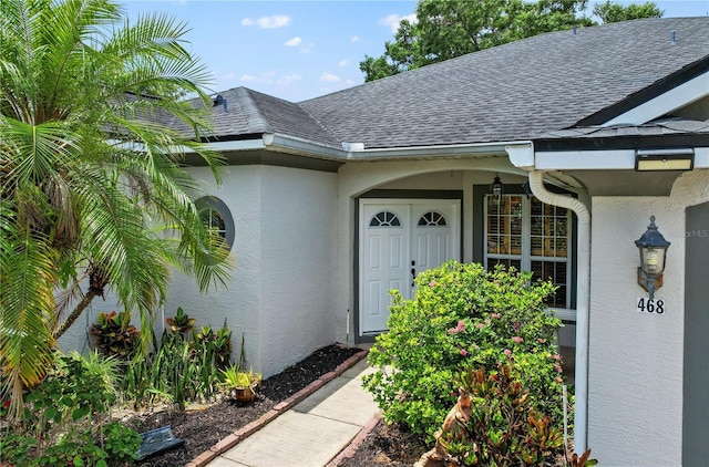 468 Alinole Loop, Lake Mary, FL 32746 - view of exterior entry featuring stucco siding and roof with shingles