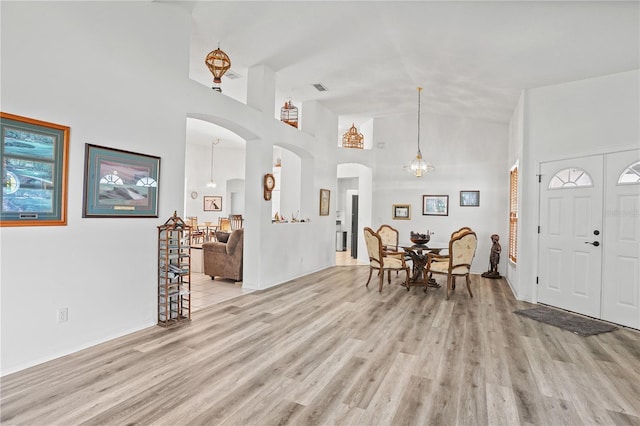 468 Alinole Loop, Lake Mary, FL 32746 - foyer entrance featuring light wood-style flooring, high vaulted ceiling, and arched walkways