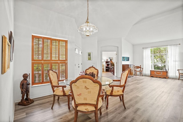 468 Alinole Loop, Lake Mary, FL 32746 - dining room featuring light wood-style floors, a chandelier, vaulted ceiling, and baseboards