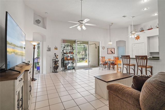 468 Alinole Loop, Lake Mary, FL 32746 - living room with ceiling fan, arched walkways, high vaulted ceiling, light tile patterned floors, and recessed lighting