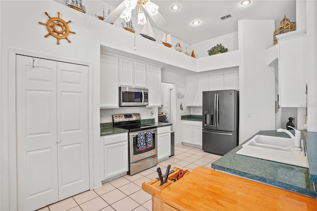 468 Alinole Loop, Lake Mary, FL 32746 - kitchen featuring appliances with stainless steel finishes, a sink, light tile patterned floors, white cabinetry, and recessed lighting