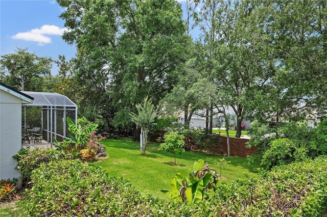 468 Alinole Loop, Lake Mary, FL 32746 - view of grassy yard with glass enclosure and a patio area