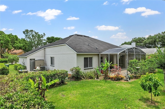 468 Alinole Loop, Lake Mary, FL 32746 - rear view of house with a lawn, a shingled roof, stucco siding, and a lanai