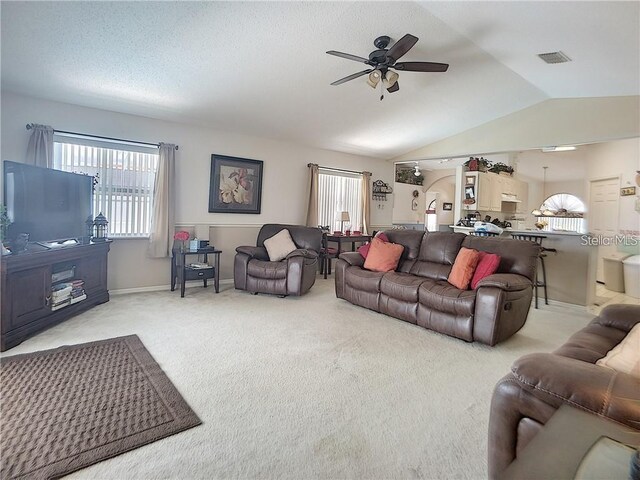 517 Westwind Dr, Davenport, FL 33896 - carpeted living area featuring a ceiling fan, healthy amount of natural light, lofted ceiling, and baseboards