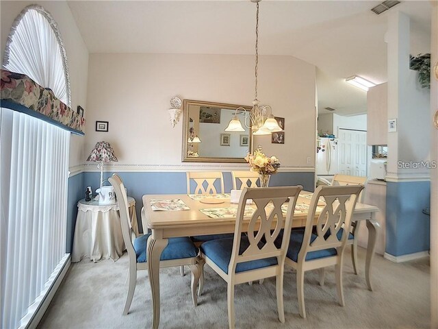 517 Westwind Dr, Davenport, FL 33896 - dining area featuring vaulted ceiling, a chandelier, and carpet