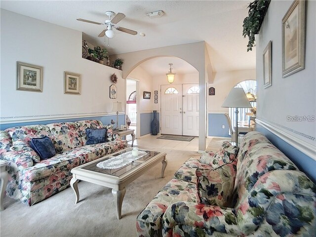517 Westwind Dr, Davenport, FL 33896 - living room with arched walkways, light carpet, and a ceiling fan
