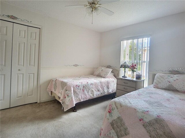 517 Westwind Dr, Davenport, FL 33896 - carpeted bedroom featuring a ceiling fan and a closet