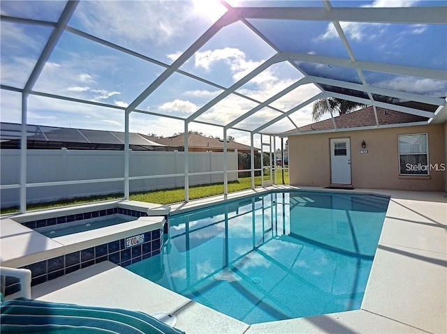 517 Westwind Dr, Davenport, FL 33896 - view of swimming pool featuring a lanai, a pool with connected hot tub, and a patio