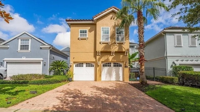 7411 Excitement Dr, Reunion, FL 34747 - view of front of home featuring stucco siding, a garage, decorative driveway, and a tile roof