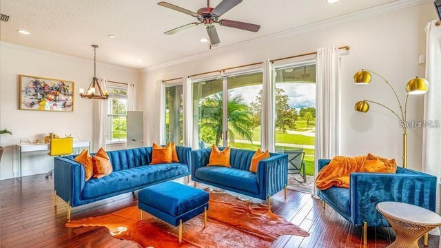7411 Excitement Dr, Reunion, FL 34747 - living room with hardwood / wood-style floors, recessed lighting, a chandelier, a ceiling fan, and ornamental molding