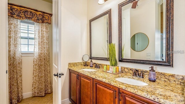 7411 Excitement Dr, Reunion, FL 34747 - bathroom with double vanity, baseboards, and tile patterned flooring