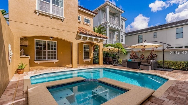7411 Excitement Dr, Reunion, FL 34747 - view of swimming pool featuring a patio, an outdoor hangout area, and a pool with connected hot tub