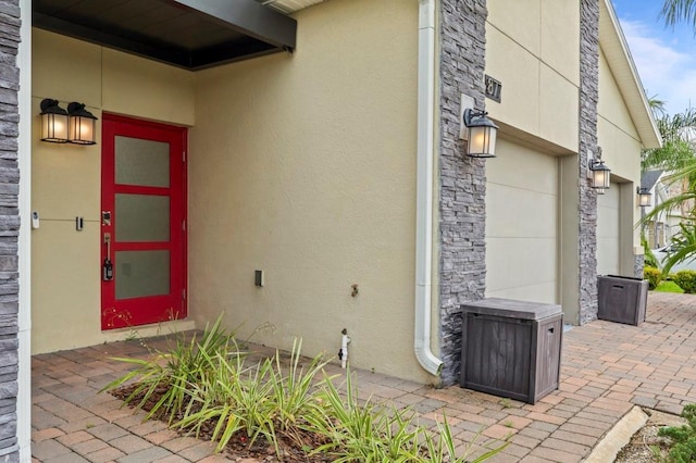 877 Ocean Course Ave, Davenport, FL 33896 - doorway to property with stucco siding and stone siding