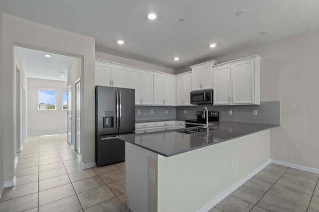 877 Ocean Course Ave, Davenport, FL 33896 - kitchen with refrigerator with ice dispenser, stainless steel microwave, a sink, backsplash, and recessed lighting