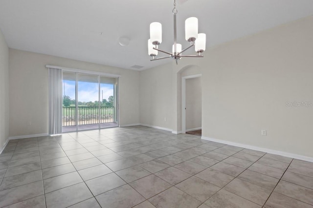877 Ocean Course Ave, Davenport, FL 33896 - spare room featuring a chandelier, light tile patterned floors, baseboards, and arched walkways