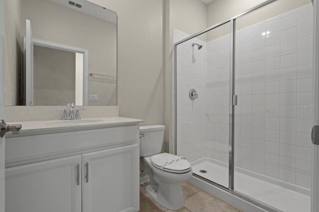 877 Ocean Course Ave, Davenport, FL 33896 - bathroom with a shower stall, toilet, vanity, and tile patterned floors