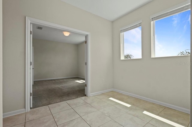 877 Ocean Course Ave, Davenport, FL 33896 - spare room featuring baseboards, light colored carpet, and light tile patterned floors