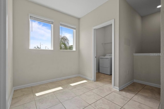 877 Ocean Course Ave, Davenport, FL 33896 - unfurnished bedroom with washer / dryer, light tile patterned floors, and baseboards