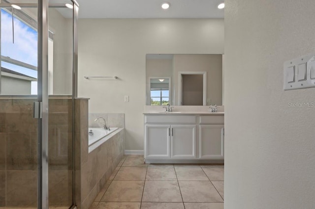 877 Ocean Course Ave, Davenport, FL 33896 - bathroom with double vanity, tile patterned flooring, a bath, and a stall shower