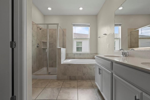 877 Ocean Course Ave, Davenport, FL 33896 - bathroom featuring a garden tub, a shower stall, double vanity, tile patterned floors, and recessed lighting