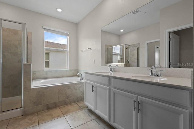 877 Ocean Course Ave, Davenport, FL 33896 - full bathroom featuring a stall shower, double vanity, tile patterned floors, a garden tub, and recessed lighting