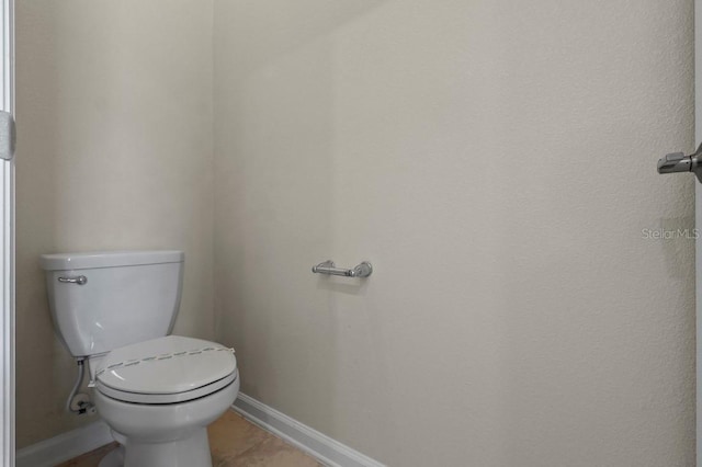 877 Ocean Course Ave, Davenport, FL 33896 - bathroom featuring baseboards, toilet, and tile patterned flooring