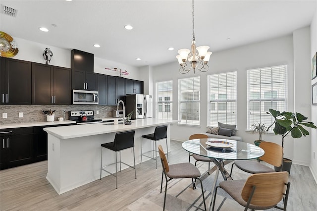 439 Windmill Palm Cir, Altamonte Springs, FL 32701 - kitchen with appliances with stainless steel finishes, a sink, tasteful backsplash, light countertops, and recessed lighting