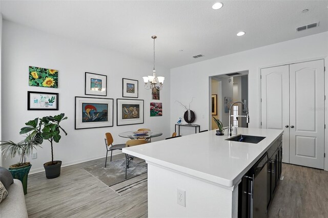 439 Windmill Palm Cir, Altamonte Springs, FL 32701 - kitchen with a sink, light wood finished floors, light countertops, a chandelier, and an island with sink