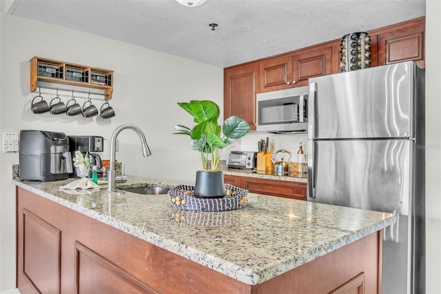 6337 Parc Corniche Dr Unit 2312, Orlando, FL 32821 - kitchen with appliances with stainless steel finishes, light stone counters, and brown cabinets