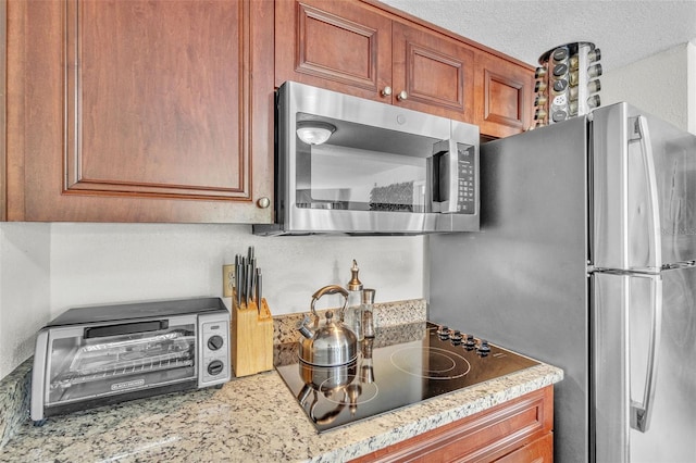6337 Parc Corniche Dr Unit 2312, Orlando, FL 32821 - kitchen with stainless steel appliances, light countertops, and brown cabinets