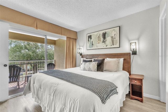 6337 Parc Corniche Dr Unit 2312, Orlando, FL 32821 - bedroom featuring access to exterior, light wood finished floors, and a textured ceiling